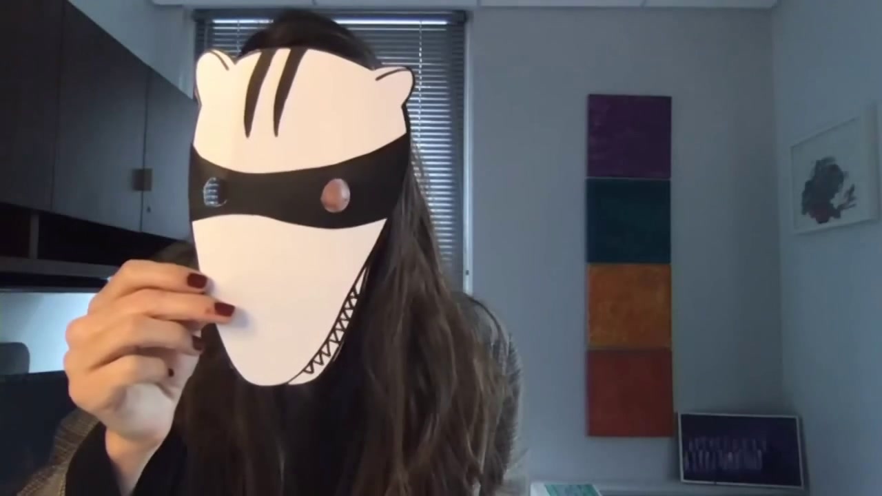 photo of Mallory Knodel with a paper mask showing a raccoon-badger like face